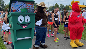 People dressed up as recycling bin character, Smoky the Bear, and Sounds chicken at start of run/walk event