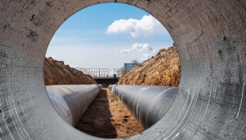 two pipes in a ground trench seen from within another pipe