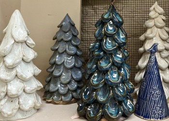 Four ceramic pine trees in shades of white and blue