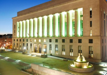 Historic Metro Courthouse lit in green at dusk
