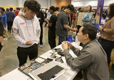 student standing at career expo table