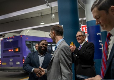 photo: Mayor O'Connell speaking with a group of men with WeGo bus in background