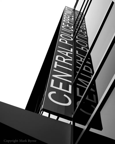 Black and white photo of Central Police Precinct sign on building