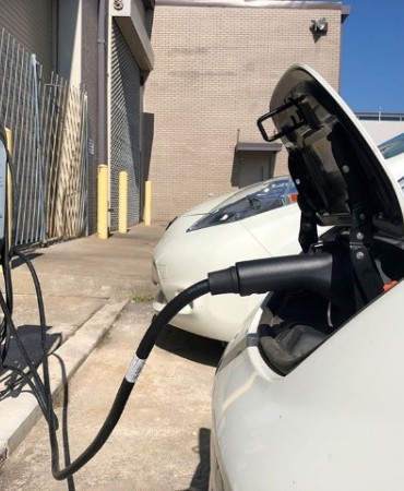 Electric vehicle plugged in at charging port