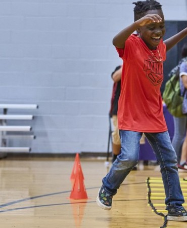 Happy Child in School Gymnasium