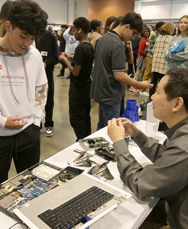 student standing at career expo table