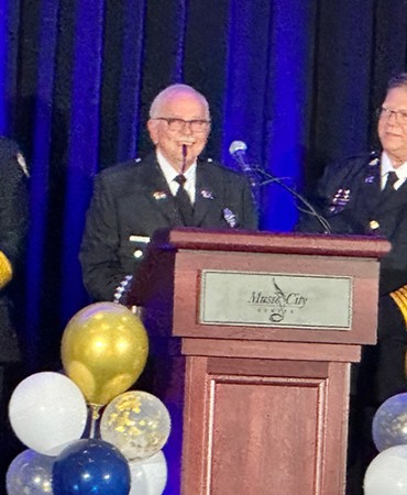 firefighters stand at a podium