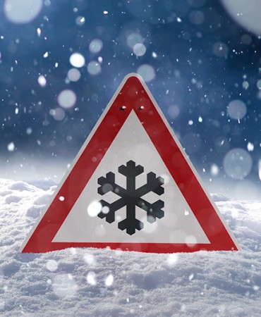 a cold weather warning sign in the snow